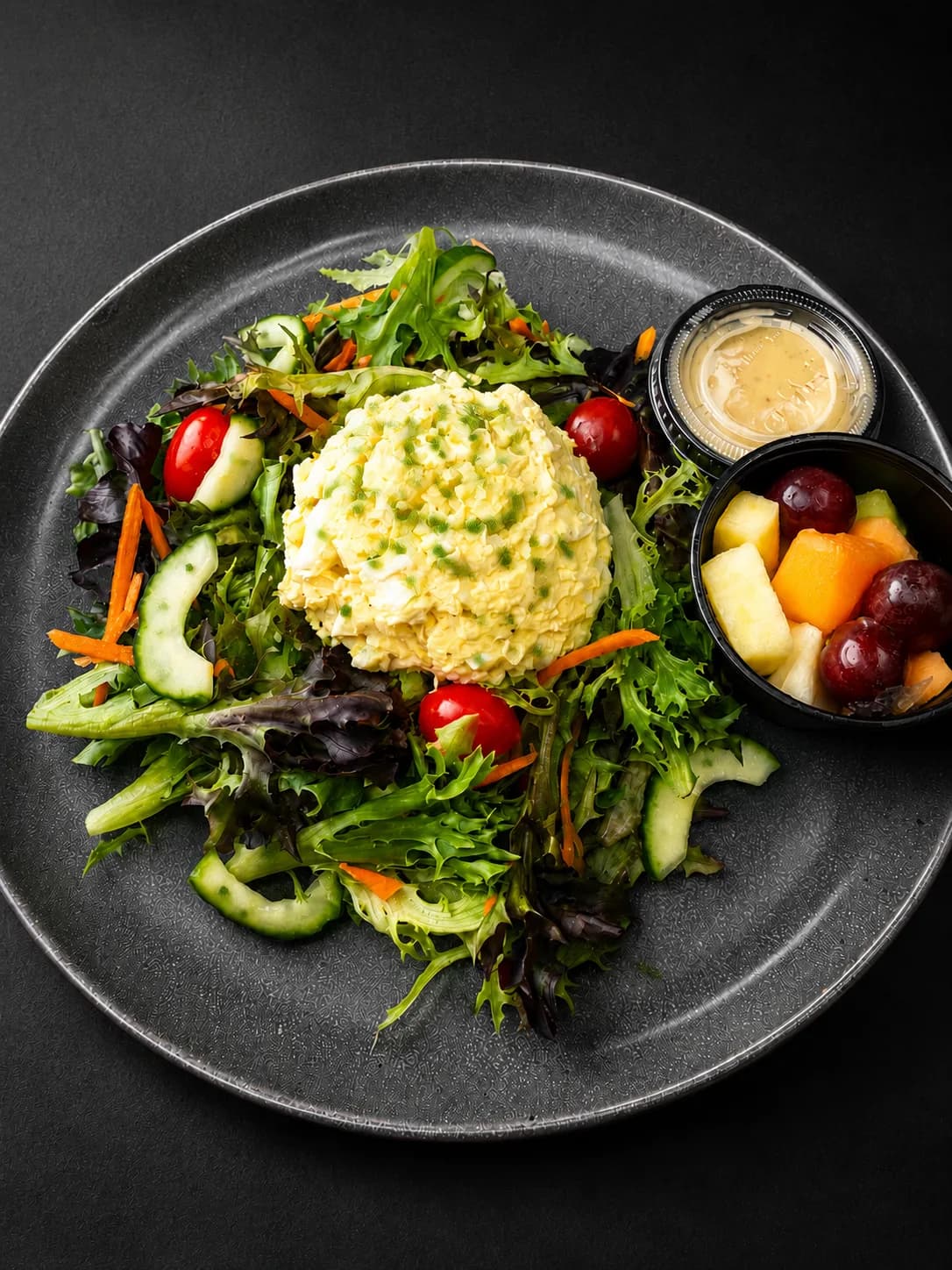 Classic Egg Salad — House-made egg salad with mixed greens, veggies, fresh fruit and honey mustard vinaigrette