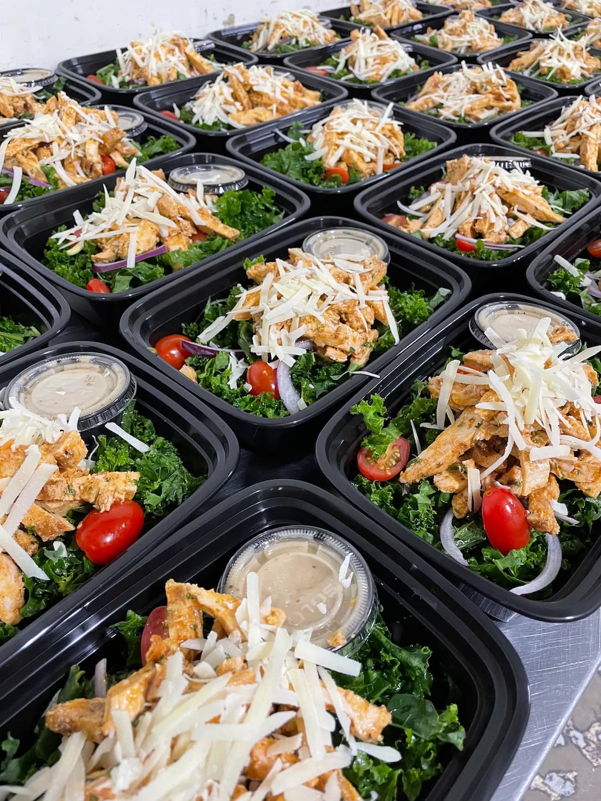 Freshly prepared baby spinach blackened chicken caesar salad