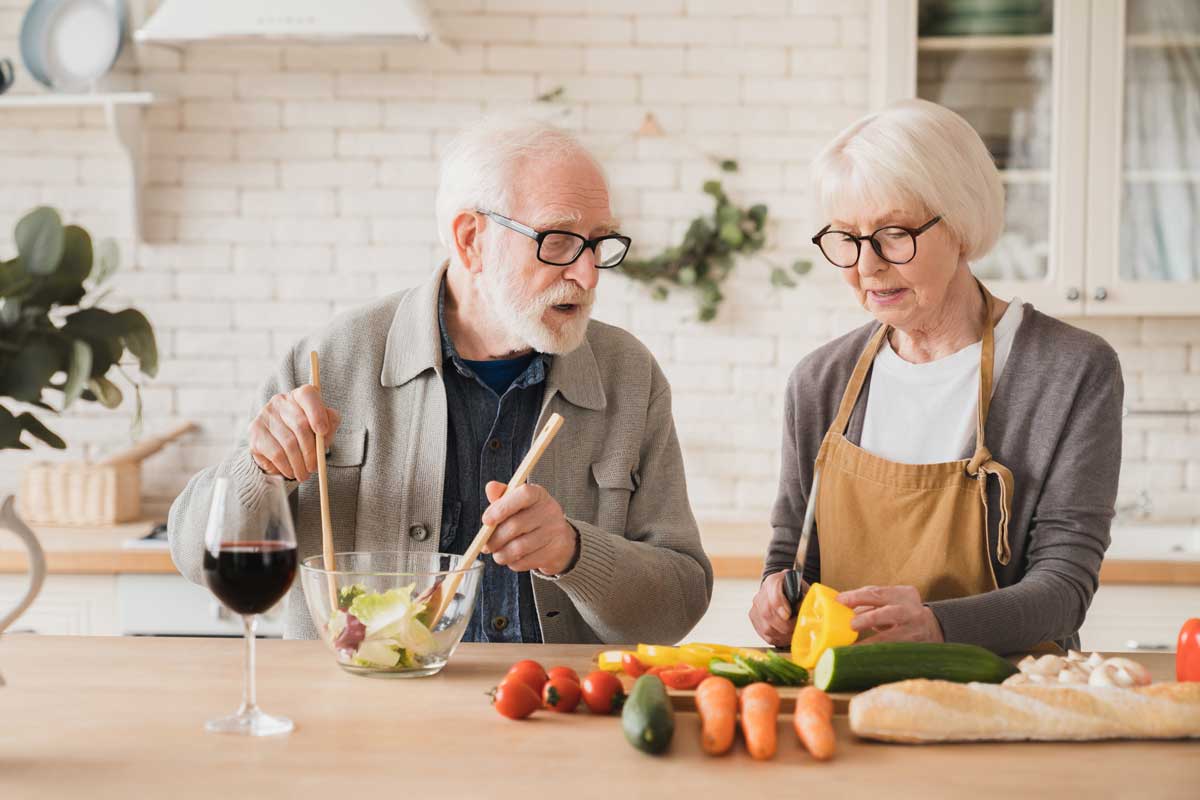 Couple making a healthy meal for blog on healthy eating for seniors