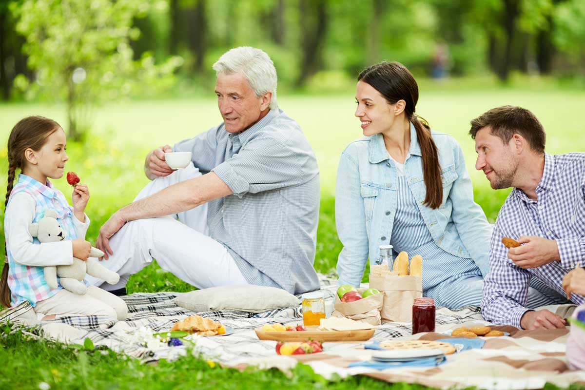 Family having a picnic eating summer picnic foods that can take the heat
