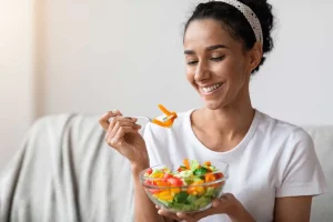 Diets include foods such as this salad a woman is enjoying