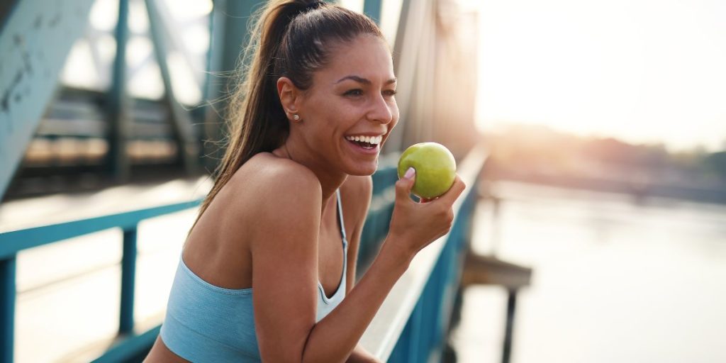 Healthy Lifestyle. Woman pictured eating an apple.