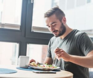 Man sitting down to eat a healthy meal. 